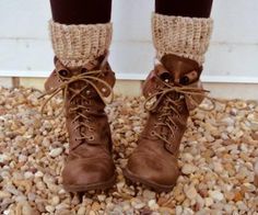 a pair of brown boots sitting on top of a pile of rocks