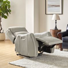 a reclining chair sitting on top of a rug in a living room