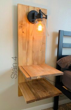 a wooden shelf with a light on it next to a wall mounted bed headboard