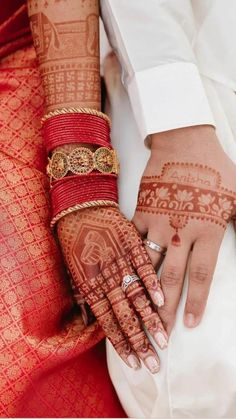 a close up of a person's hands with hennap on their fingers