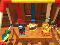 a wooden table topped with lots of toy items and toys on it's legs