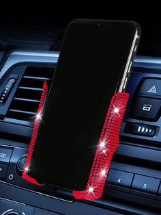 an image of a cell phone holder in the middle of a car dashboard with diamonds on it