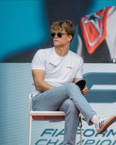 a man sitting on top of a white chair