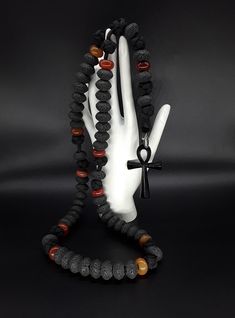 The Ankh Paracord Rosary is a unique 5 Decade Catholic Rosary that is based on the foundation of of Volcanic Lava stone that is directly extracted from Mt Vesuvius (all stones have been purified and cleansed). On top of that, it is supported by Carnelian beads and a black stainless steel Ankh Cross symbolizing the eternal life. Moreover, the rosary has been officially blessed by the church. If you are looking for a rosary that differentiates itself from the rest, the Ankh Paracord Rosary is the Mens Rosary Necklace, Mt Vesuvius, Mens Rosary, Paracord Rosary, Cross Rosary, Ankh Cross, Griffey Jr, Frame House, Natural Jewelry