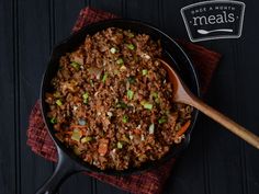 a pan filled with meat and vegetables on top of a table