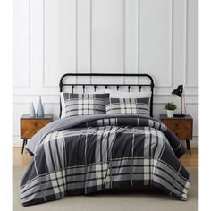 a black and white plaid comforter set on a bed with two nightstands in the background