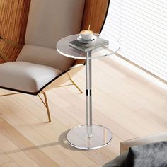 a glass table sitting on top of a hard wood floor next to a white chair