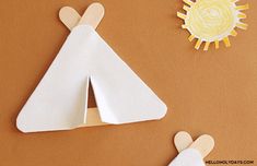 paper cut out of the shape of a child's teepeeh and sun