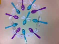 a group of blue and white dragonflys sitting on top of a table