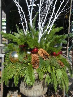 a potted plant with pine cones and ornaments