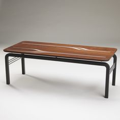 a wooden table sitting on top of a metal frame