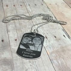 a dog tag that says baby, i love you forever on it with an image of two people