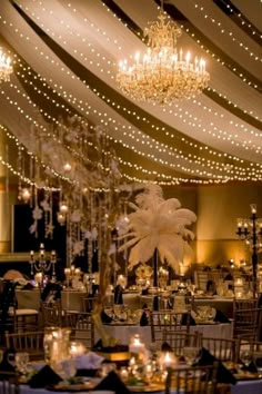 a banquet hall with chandeliers and tables set up for an elegant dinner party