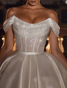 a woman in a wedding dress is posing for the camera with her hands on her hips