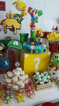 a table topped with lots of cakes and cupcakes