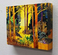 a painting is hanging on the wall in front of a white wall with trees and bushes