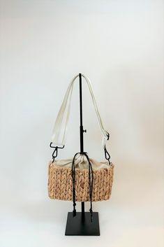 Because of your enormous love of The Fullerton and St. Augustine bags, we added a 3rd bag to this straw family. Introducing the smallest version of this collection we call the Hamptons. Inspired by all the mini bag trends and designed with all our signature straw materials and details. Drawcord top to hold your belongings in place, finished with an adjustable white nylon and leather strap make this bag a fun and easy choice for a sunscreen, phone and keys kinda day. *color may vary slightly by b Bag Trends, St Augustine, The Hamptons, Mini Bag, Sunscreen, Leather Straps, Straw, Leather, White