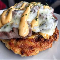 a close up of a plate of food with meat and cheese on it's side