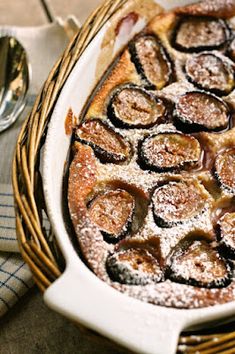 a baked dish in a wicker basket with powdered sugar on top