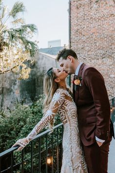 a newly married couple kissing on the balcony