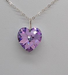 "This beautiful Swarovski Crystal Vitrail Light heart-shaped pendant hangs on a sterling silver chain. **Crystal Vitrail Light is a mix of pinks, purples, and blue that vary depending on the light angle. Pick you chain: 16\" Cable, 18\" Cable, 20\" Cable, or 24\" Cable Pendant Size: 18mm Necklace is packaged in a white cotton-filled gift box. **Matching Earrings Available** https://www.etsy.com/SunshineJazzyJewels/listing/660601398/sterling-silver-swarovski-crystal?utm_source=Copy&utm_medium=Lis Crystal Teardrop Earrings, Crystal Heart Pendant, Swarovski Crystal Jewelry, Snake Pendant, Drop Necklace, Heart Jewelry, Sterling Silver Chain, Teardrop Earrings, Matching Earrings