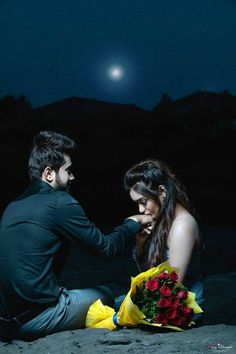 a man kneeling down next to a woman holding flowers