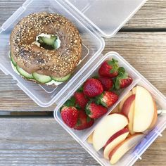 two plastic containers filled with food on top of a wooden table