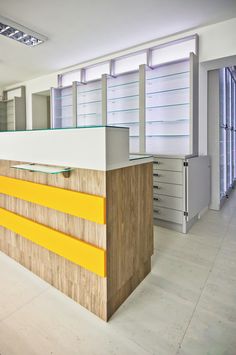 an empty office with yellow and white counter tops