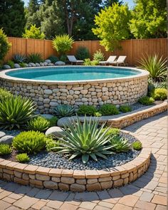 an outdoor pool surrounded by plants and rocks