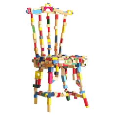 a colorful wooden chair made out of colored pegs on a white background with the word love spelled across it