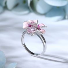 Turn up the flower power with this pink flower ring. Crafted in sterling silver, features every petals hand-painted in rich enamel, decorated with white stones, making every flower completely unique. An organically shaped band mimics a real stem and evokes the freedom of spring. Wear yours as a reminder of all the loved ones in your life.Carat Weight: 2.31 ctStone Shape: Oval, RoundStone Size: 6*8,1,1.2 mmNumber of Stones: 30 Stone Color: Diamond WhiteWeight: 4.3 gWidth: 2.4 mmHeight: 9 mmThickn Pink Silver Jewelry, Pretty Rings Silver, Pink Flower Ring, Dreamy Garden, Beautiful Wedding Rings, White Stones, Spring Wear, Jewelry Accessories Ideas, Accessories Ideas