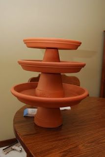 an orange vase sitting on top of a wooden table