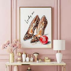 a pink room with a painting on the wall and a pair of high heeled shoes