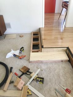 tools are laying on the floor in front of stairs