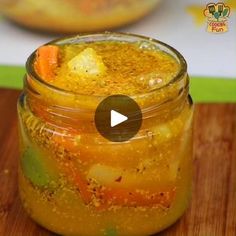 a jar filled with food sitting on top of a wooden table