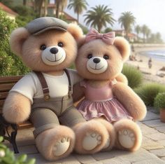 two teddy bears are sitting on a bench near the beach and palm trees, one is wearing a pink dress