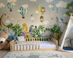 a child's room with a crib, bed and wall mural