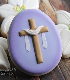 a cookie decorated like a cross with cookies in the background