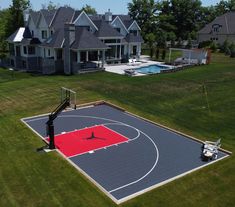 an aerial view of a basketball court and house