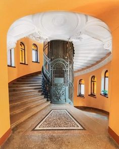 an arched doorway leads to a spiral staircase