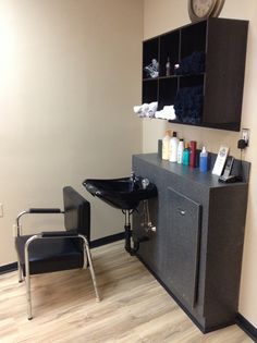 a chair and counter in a room with a clock on the wall next to it