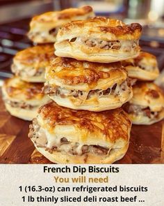 a pile of french dip biscuits sitting on top of a wooden cutting board next to a frying pan