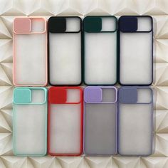 six different colored cases sitting next to each other on top of a white surface with geometric shapes