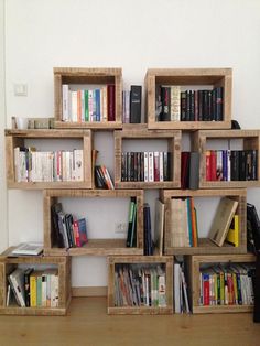 the bookshelf is made out of wooden crates