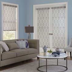 a living room filled with furniture and blue walls