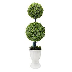 a potted plant with two topiary balls on it's sides in a white vase