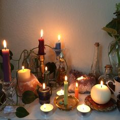 a table topped with lots of lit candles