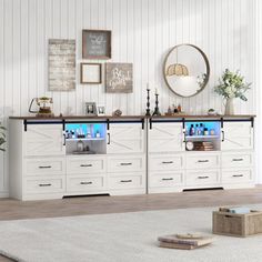 a large white dresser sitting in a living room next to a wall with pictures on it