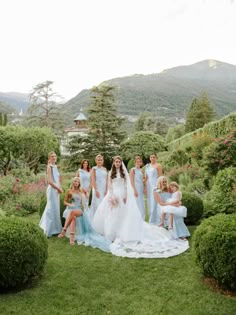 a group of women standing next to each other on top of a lush green field