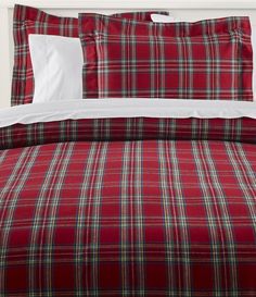 a red plaid comforter set with white pillows